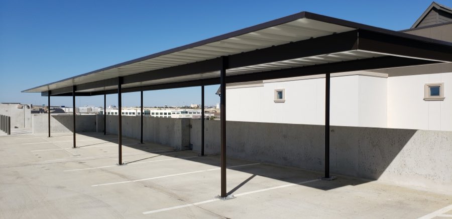 Four-post carport on a parking garage rooftop