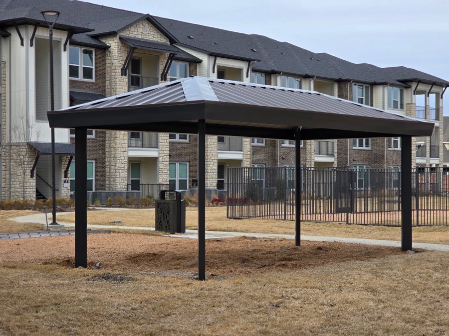 Four-post hip roof patio cover at an apartment community